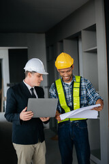Architect caucasian man working with colleagues mixed race in the construction site. Architecture...