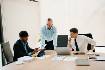  Business people sum up the results of their work in the company during the year, new project in office.