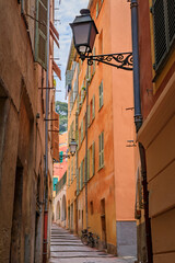 Fototapeta na wymiar Narrow crooked street in the Old Town, Vieille Ville in Nice, French Riviera