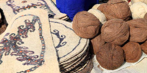 Felt rugs and balls of camel wool. Turkmenistan. Ashkhabad market. - 582958517