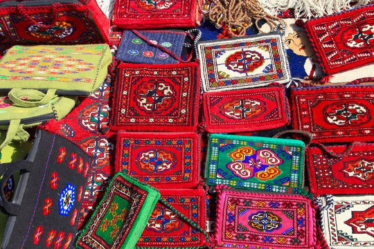Handmade decorative bags and carpets with traditional ornament. Turkmenistan. Ashkhabad market.