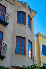 Spire or turret style bedroom building apartment complex or townhome house stucco beige exterior brown window frames