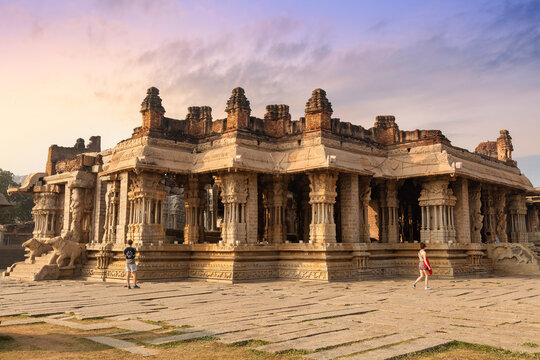 Ancient stone architecture ruins inside Vijaya Vittala temple complex at Hampi Karnataka at sunrise.
