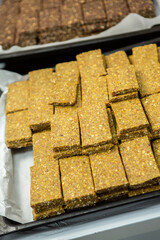 Assortment of cereal or protein bars that leave the assembly line at the factory. Healthy pre or post workout snacks with fruits, nuts and berries. 