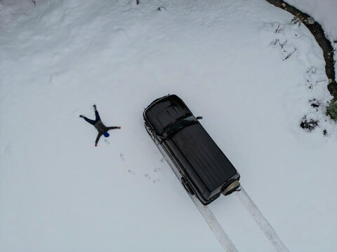 amazing aerial photo of adventurous man and his vehicle