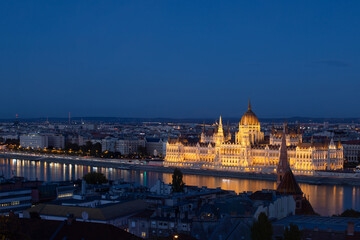 Fototapeta na wymiar Budapest parliament illuminated at night and Danube river, Hungary
