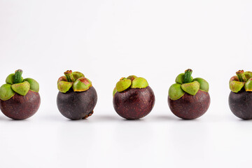 Queen of Fruit in Thailand. Fresh mangosteen fruit and half mangosteen isolated on white background. Close-up 