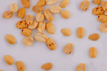 Heapof roasted peanuts close up on a white. Isolated.