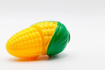 plastic toy corn on white background