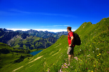 Hiker at the mountain lake, Seealpsee, Allgäu Alps, Bavaria, Oberstdorf, Germany.