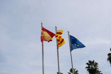 Flags spain european union catalonia on blue sky background