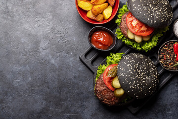 Homemade beef burgers with black buns