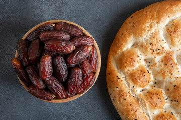 Date fruits with Ramadan pita on black backgrpund