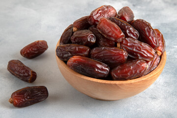 Date fruits in wooden bowl,top view