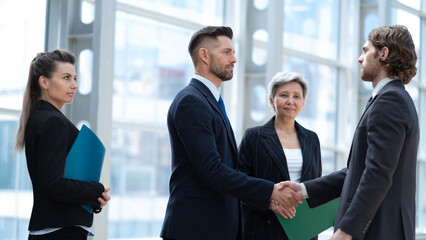 Corporate executives shaking hands