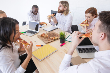Business team eating sharing pizza