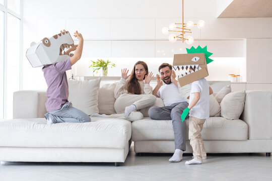 Children play cardboard dinosaur costume