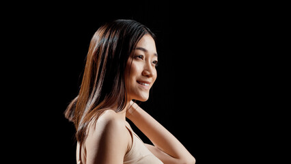 Female model with natural bare skin posing for beauty ad, promoting gentle uplifting products in studio. Woman expressing self love and beauty of imperfections, radiant glowing look.