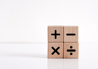 Basic mathematical operations symbols. Plus, minus, multiply and divide symbols on wooden cubes on white background.