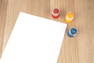 Art Supplies surrounding Blank Paper Mockup Concept Flat Lay