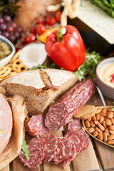 Salami sausage close-up. Table full of mediterranean appetizers, tapas or antipasto. Assorted Italian food set. Delicious snack on party or picnic time. Meat and cheese. Italian style banquet. 