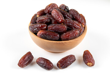 Date fruits in wooden bowl,on white background,top view