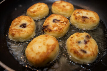 Homemade tasty cheesecakes are fried in pan,  traditional dish Ukrainian