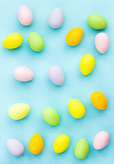 Stylish background with colorful easter eggs on blue background with copy space