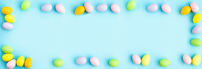 Stylish background with colorful easter eggs on blue background with copy space