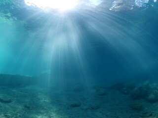sun rays sun beam and sun shine on rocks underwater