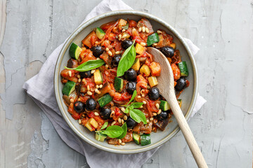 ratatouille with onion tomatoes, celery, zucchini, black olives, celery, pine nuts and basil