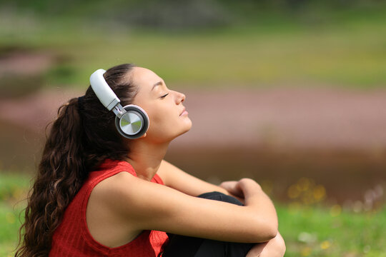 Woman in nature listening audio