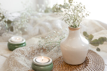 Fototapeta na wymiar Spring composition with gypsophila flowers and candles.
