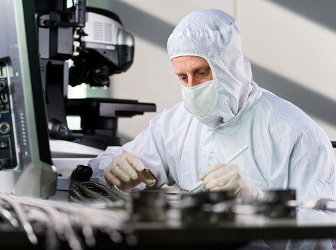 Technician wearing protective suit working in laboratory