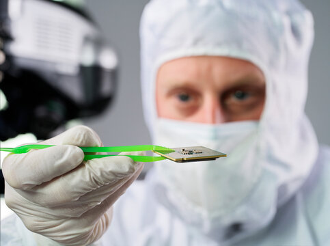 Scientist holding computer chip in laboratory