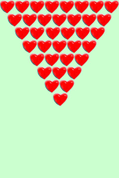 Rows of heart shaped candy flat laid against green background
