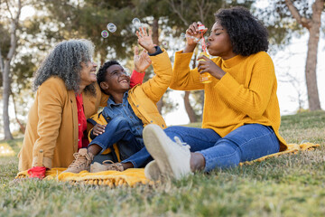 Happy multi-generation family having fun together in park