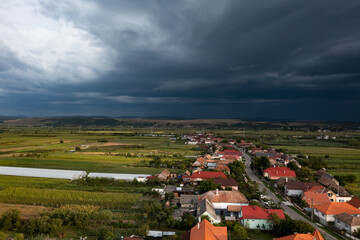 Fototapeta na wymiar Summer storm over a small village in Romania.
