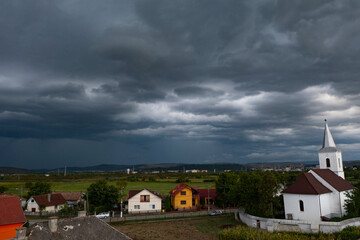 Fototapeta na wymiar Summer storm over a small village in Romania.