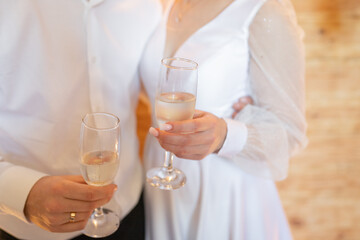 bride and groom holding champagne glasses