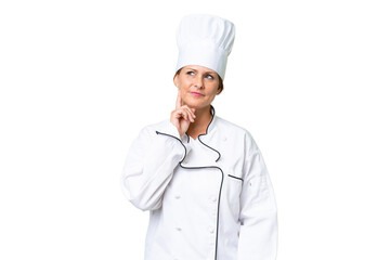 Middle-aged chef woman over isolated background thinking an idea while looking up