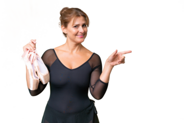 Middle-aged caucasian woman practicing ballet over isolated background pointing finger to the side