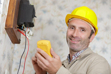 an electrician installs a socket