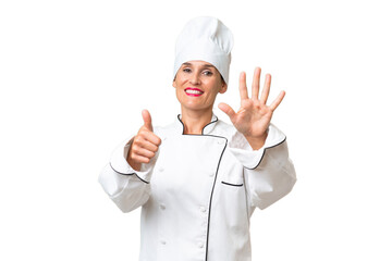 Middle-aged chef woman over isolated background counting six with fingers