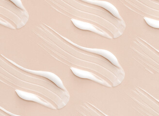 pattern cosmetic smears of creamy texture on a beige background	
