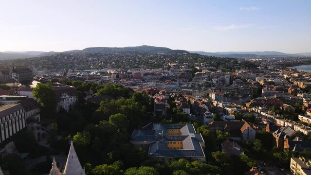 Aerial view of historical buildings in Buda. Drone flying towards Three Border Mountain (H&aacute;rmashat&aacute;r-hegy)