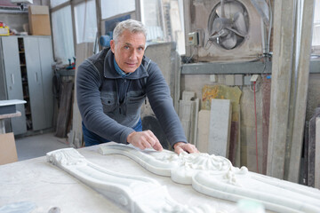 senior craftsman working marble cornice