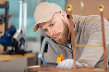 young man working on copper pipes