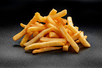Pile of french fries over black background