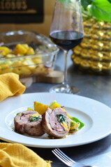 Fototapeta na wymiar pork stuffed with spinach and egg , a side dish of fried potatoes with spring onions , a view of a beautiful spring light colorful meal